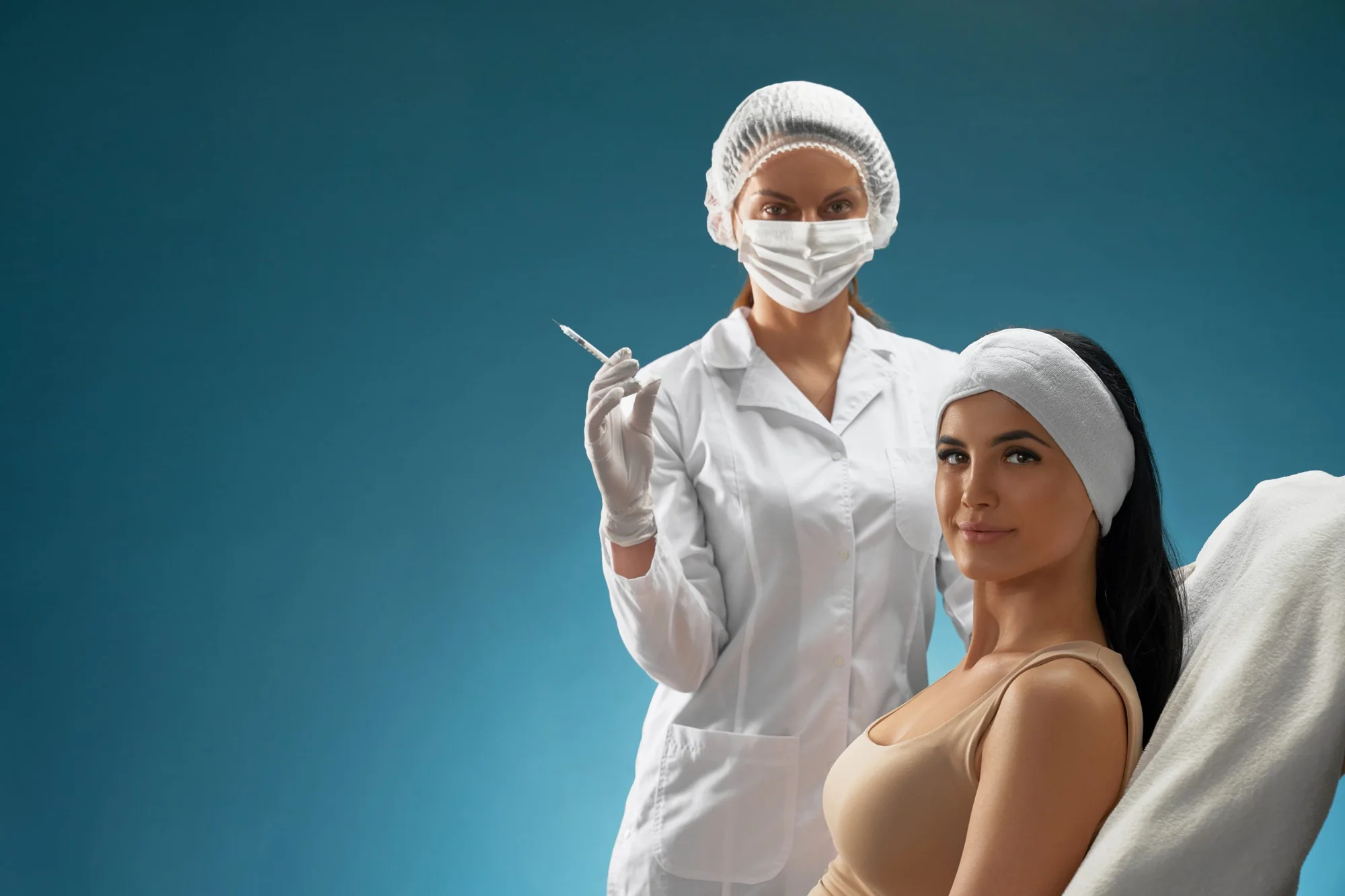 A clinician preparing an injectable treatment beside the treatment chair