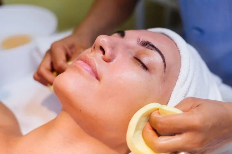 The face being cleansed with sponges after an exfoliating treatment