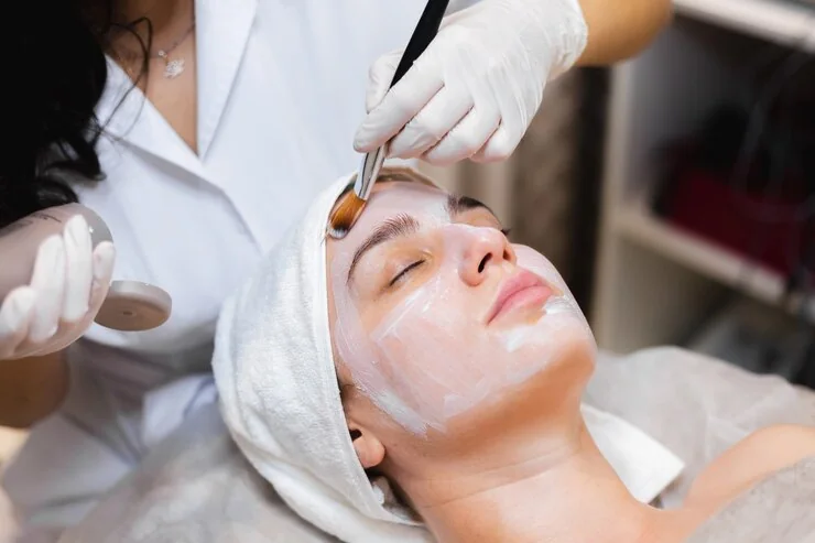 A treatment mask being applied to the face with a brush